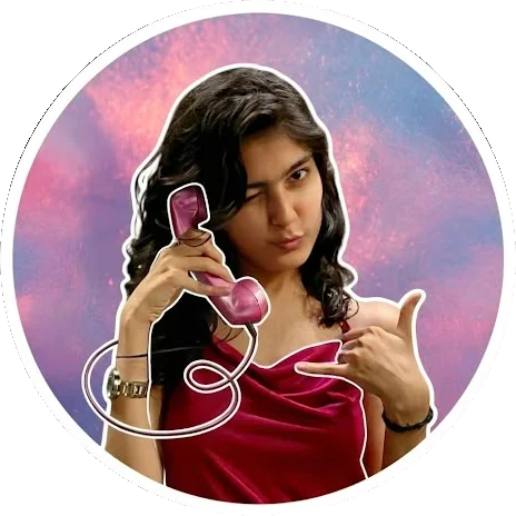 Diya Nathwani winking, holding a pink toy phone